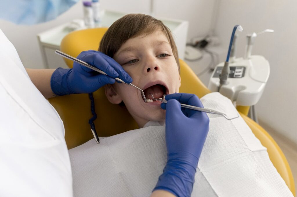 Dentist cleaning child's teeth